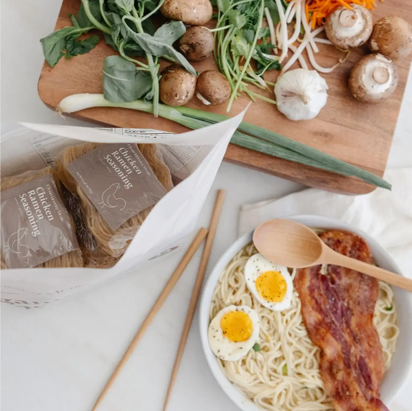 Clean Monday meals: ramen noodles on a counter with a cutting board, with vegetables, ramen noodles with eggs and bacon