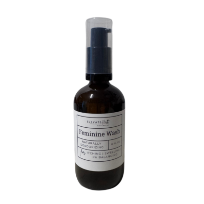 Feminine wash an amber glass bottle with a spray top showing product label
