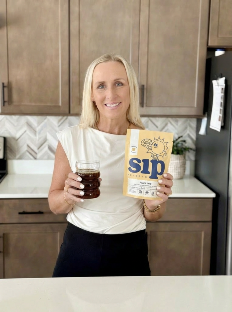 Sarah holding Sip Herbals pouch and coffee mug