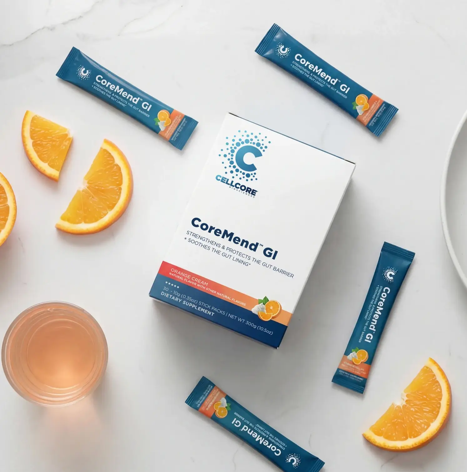 Box of coremend GI with packets and cut up oranges with a glass next to it